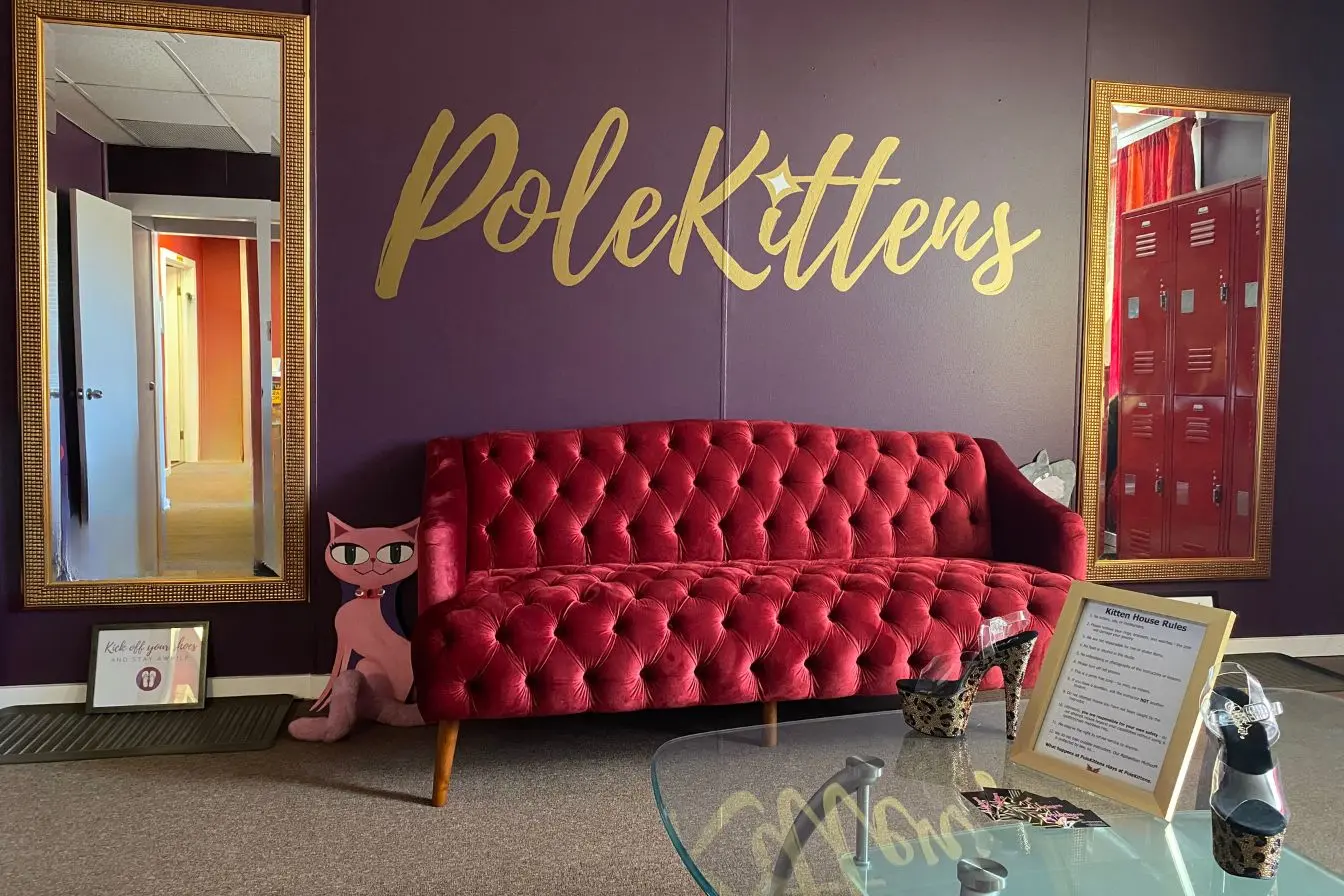 PoleKittens lounge with red velvet couch and gold-framed mirrors